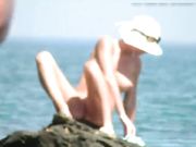 Nude Russian babe with nice tits filmed naked on a rock at public beach