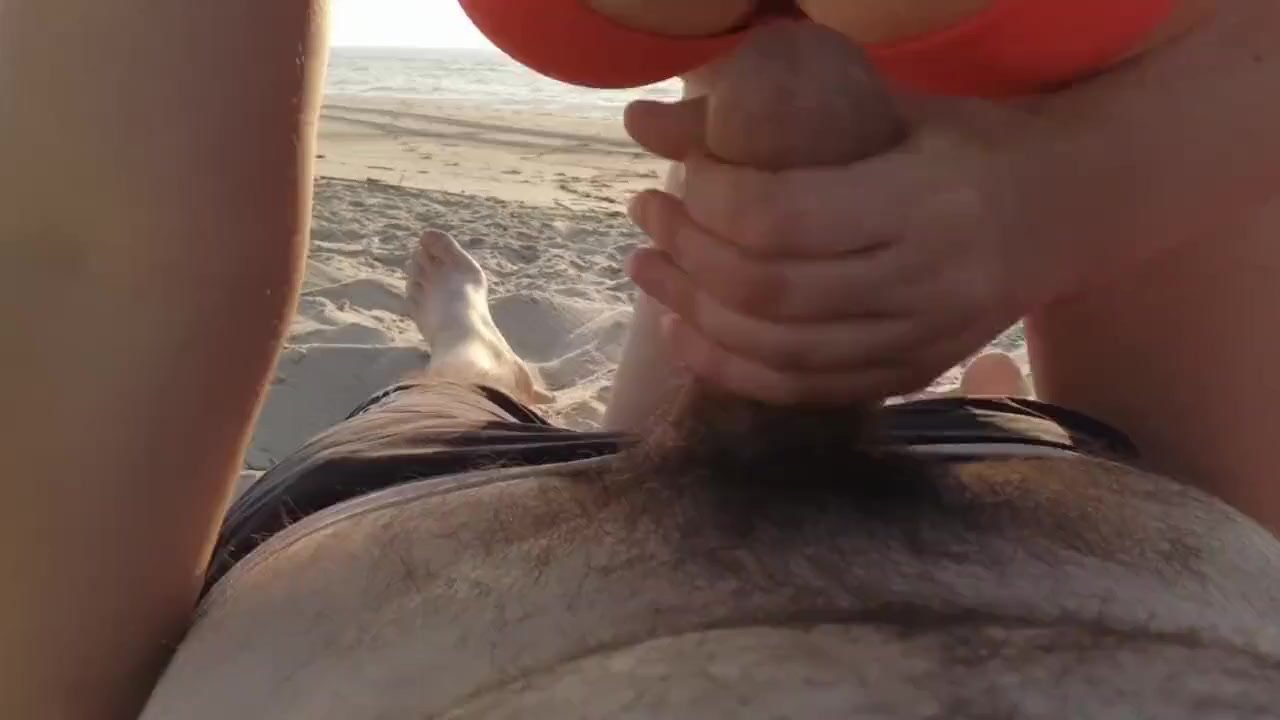 Real amateur handjob at the beach with cum tasting image