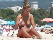 Fine looking topless girl at the beach spied on voyeur camera