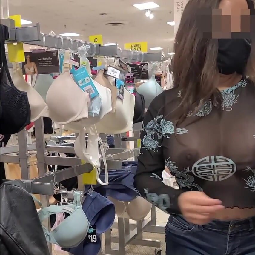Bombshell spouse with big tits wearing see through blouse in store revealing her nipples pic